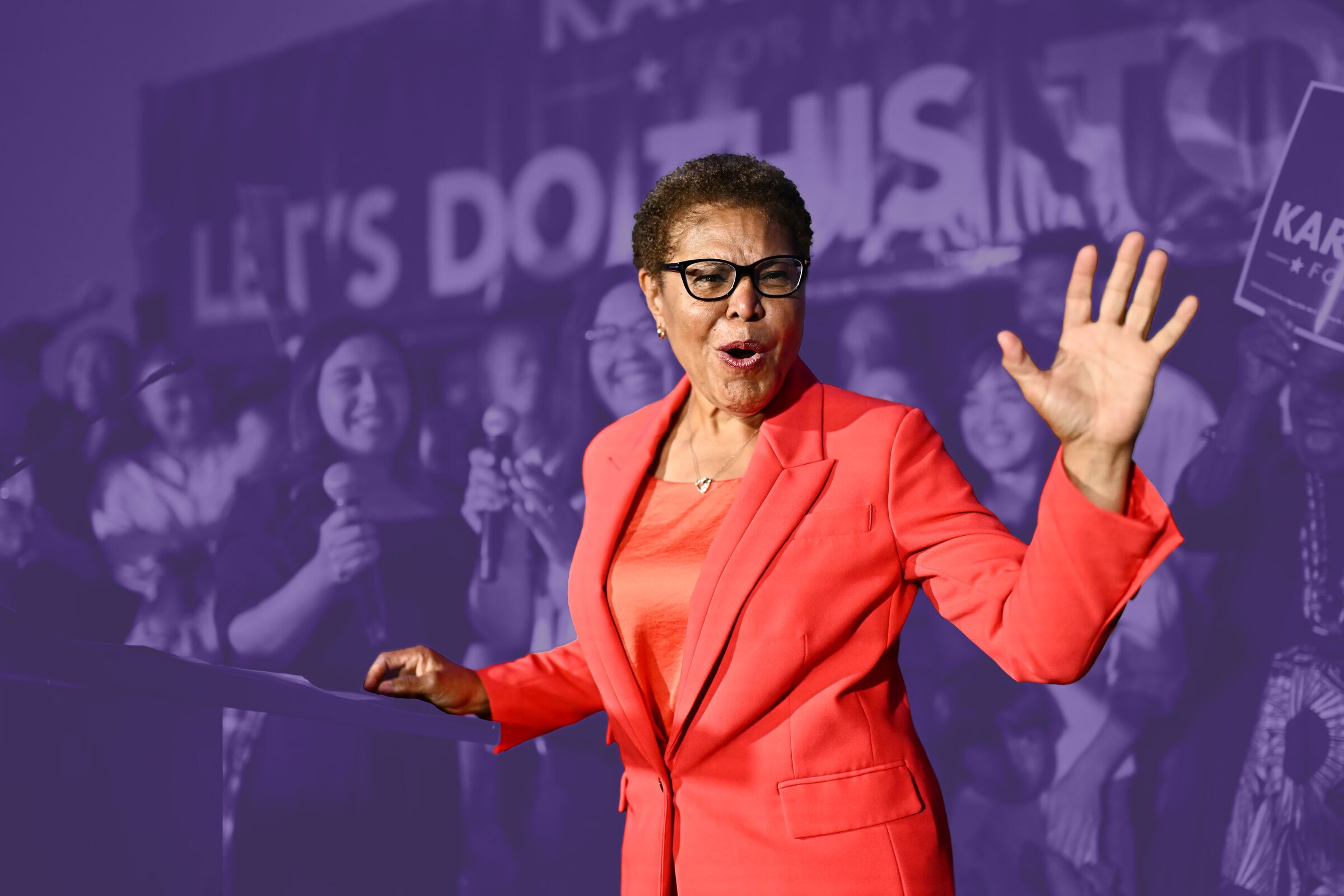 Mayor Karen Bass speaking from a Let's Do This podium, photographed in purple duotone