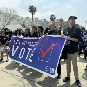 LMU NTT faculty and students march together holding a sign that reads "Let NTT Faculty Vote"