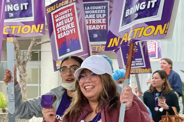 Union members with picket signs march outside the Harbor-UCLA Medical Center in Torrance.