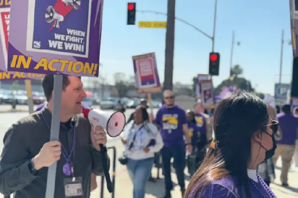 SEIU 721 President David Green speaks from a bullhorn while in a picket line outside the Metro North DCFS building in downtown LA.