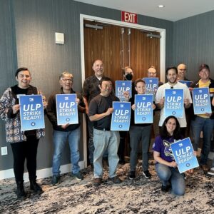 USD NTT Faculty union members holding signs saying "ULP Strike Ready!"