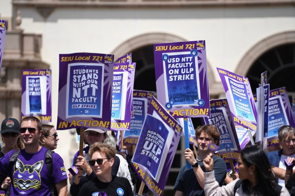 USD NTT Faculty Union members marching holding ULP Strike picket signs