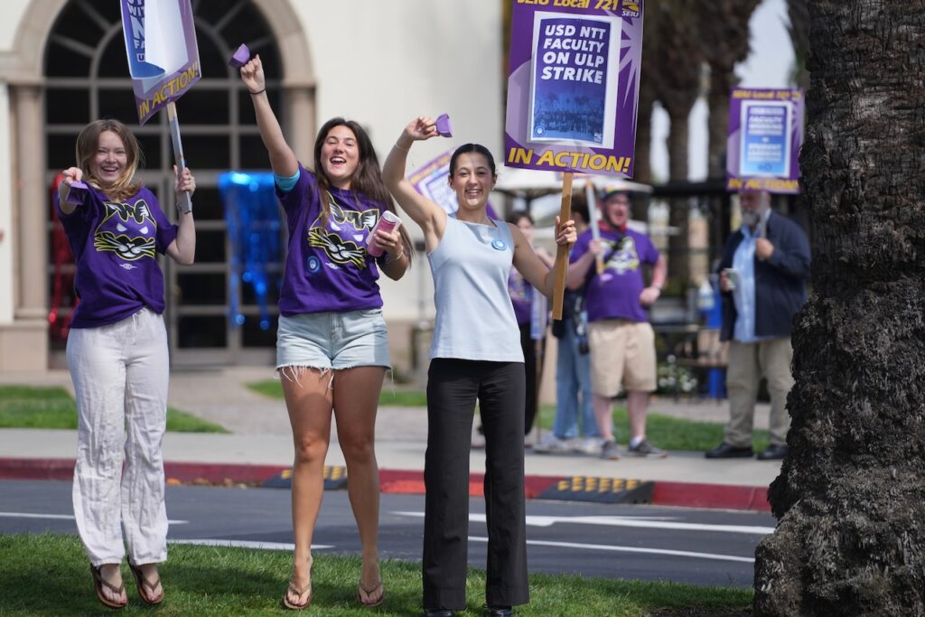 USD students cheering with picket signs