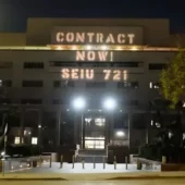 Light projection onto LA County's Hall of Administration. The projection reads: Contract Now! SEIU 721.