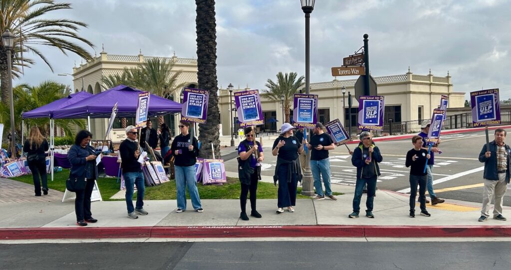 USD NTT Faculty Union members holding ULP Strike picket signs at the entrance to the school