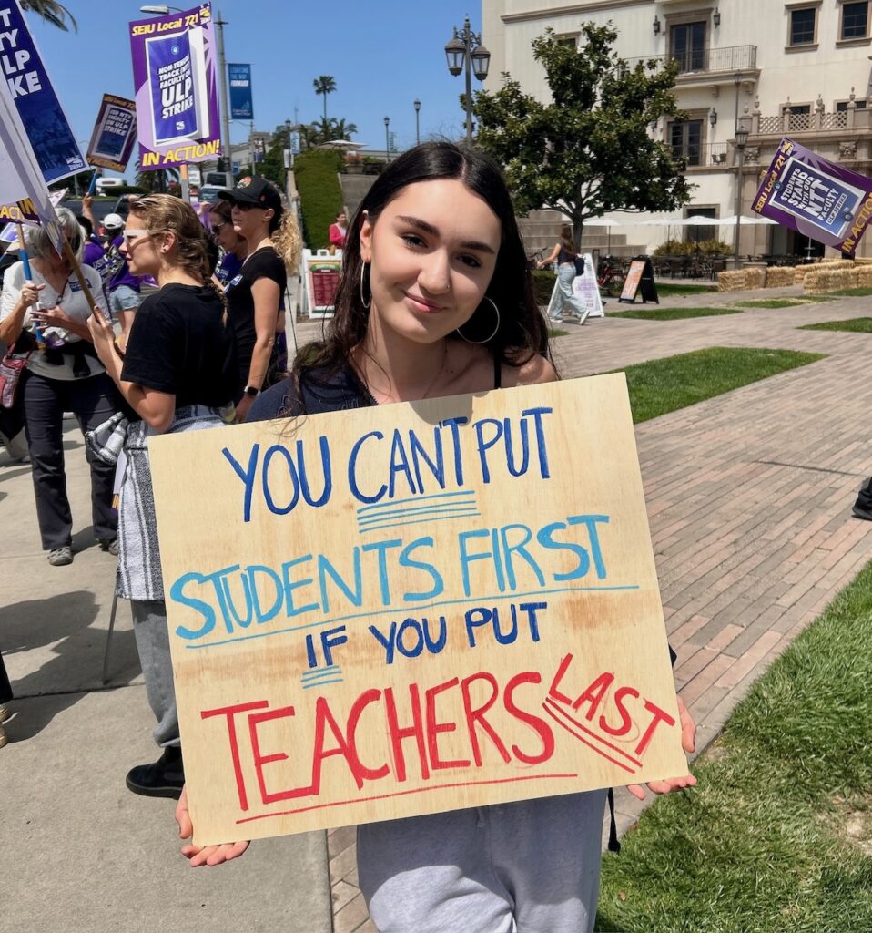 USD student holding a sign saying "You can't put students first if you put teachers last"