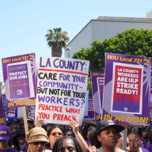 SEIU 721 marching and holding signs. One sign reads: LA County care for your community but not for your workers? Practice What You Preach.
