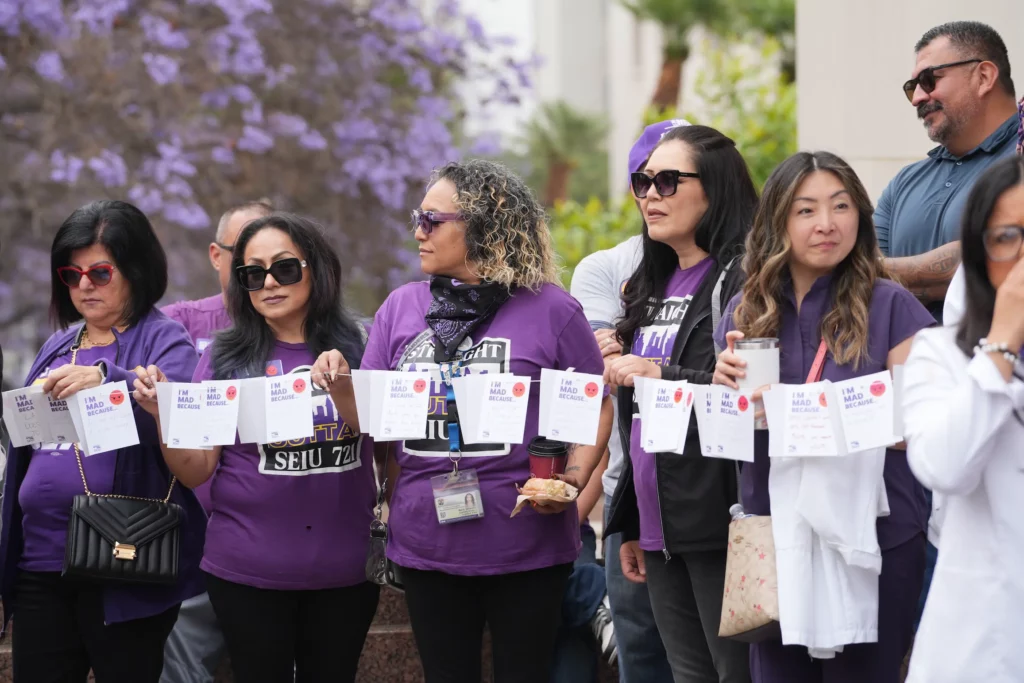 LA County members standing and holding personal letters tied to a clothesline.