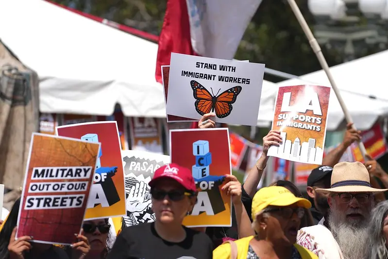 Workers from a variety of labor unions hold pro-immigrant signs at the "Summer of Resistance" launch in downtown Los Angeles.